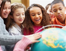 Students looking at globe